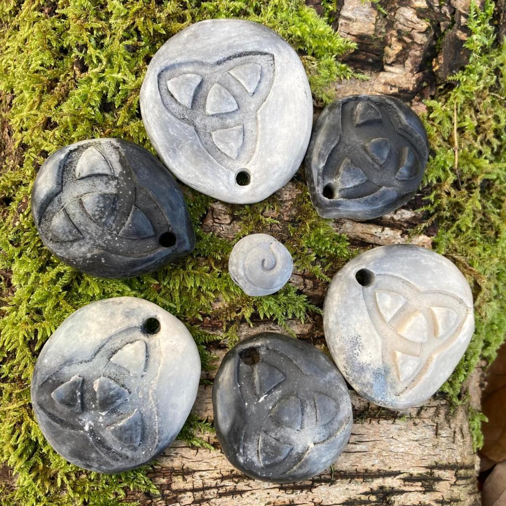 shows smoke or pit-fired pottery similar to what you will make on the course